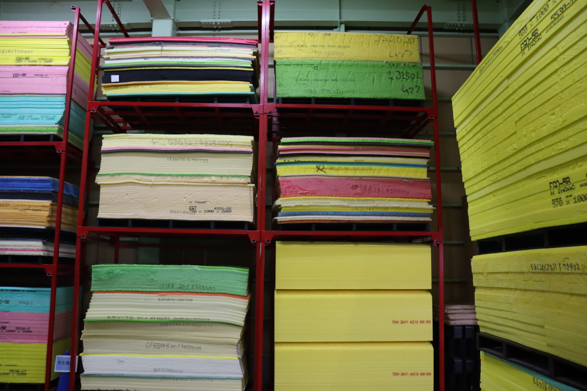 Colourful urethane foam storage racks lined up in our warehouse