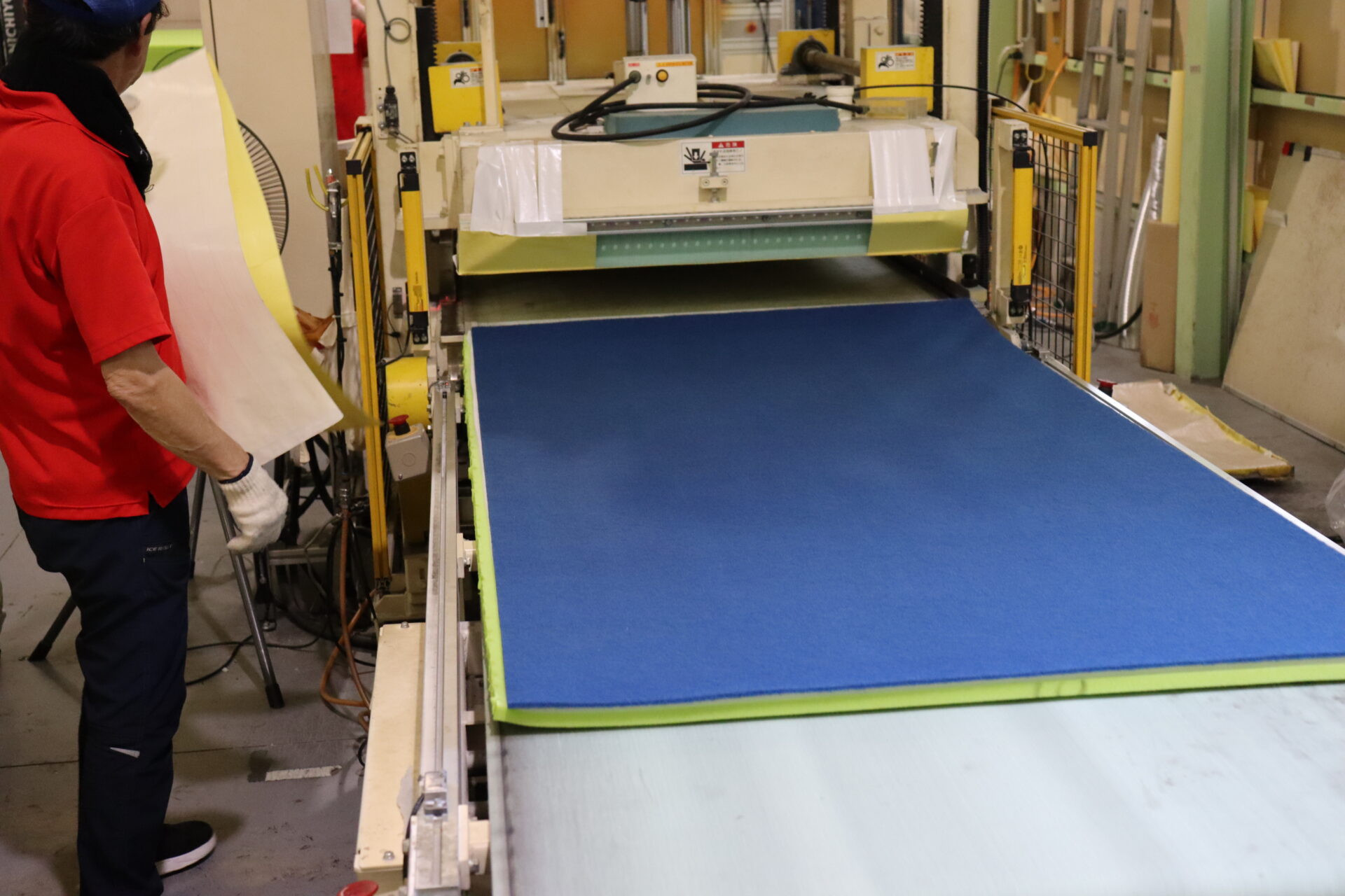 Automated press bonding machine compressing laminated layers