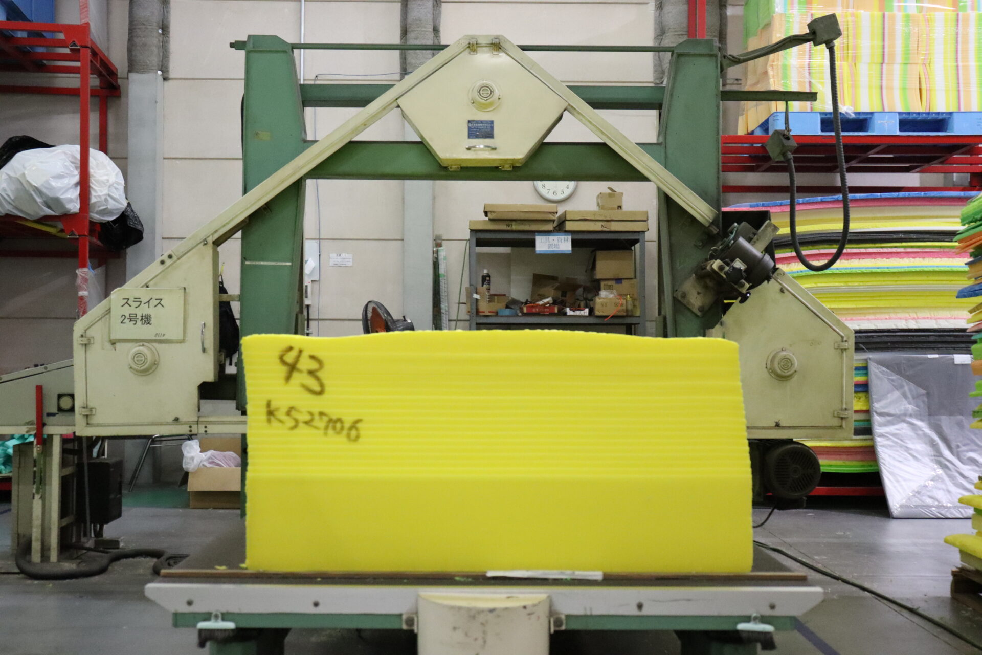 Table slicing machine cutting foam into thin sheets