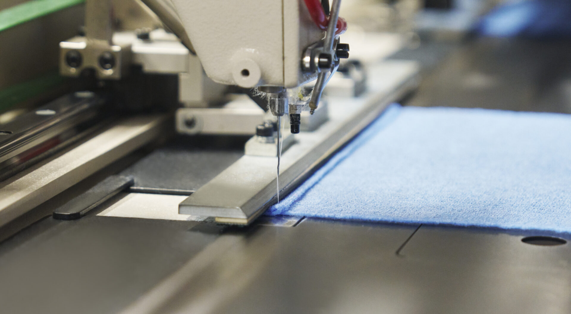 Industrial sewing machine finishing a Japanese body towel