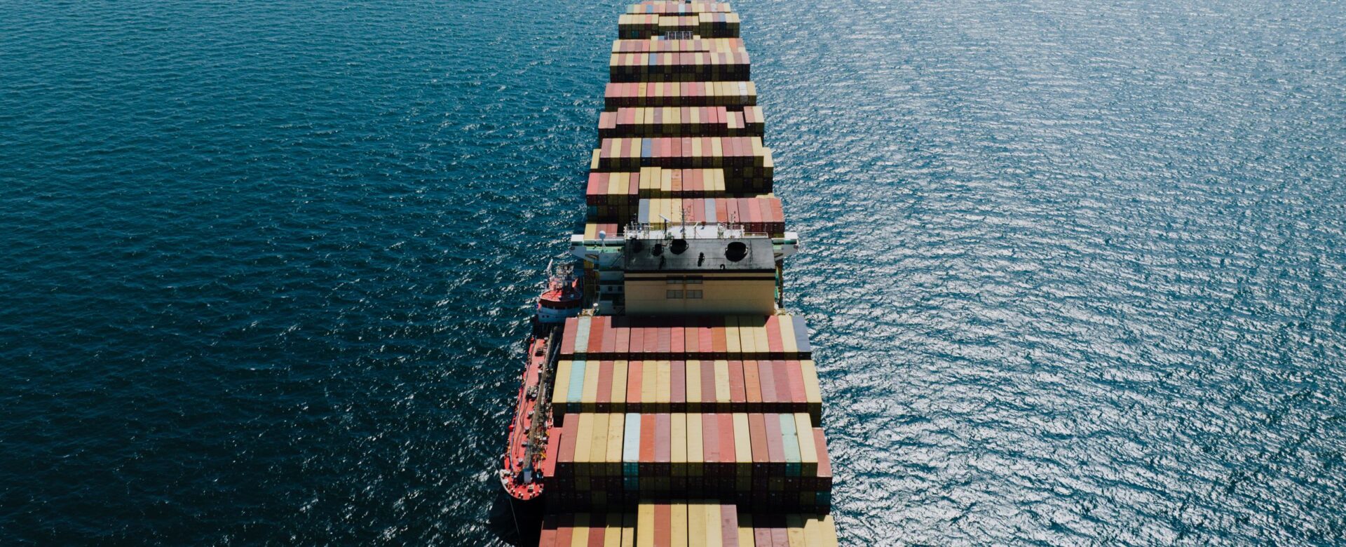 Container ship laden with containers sailing out to sea